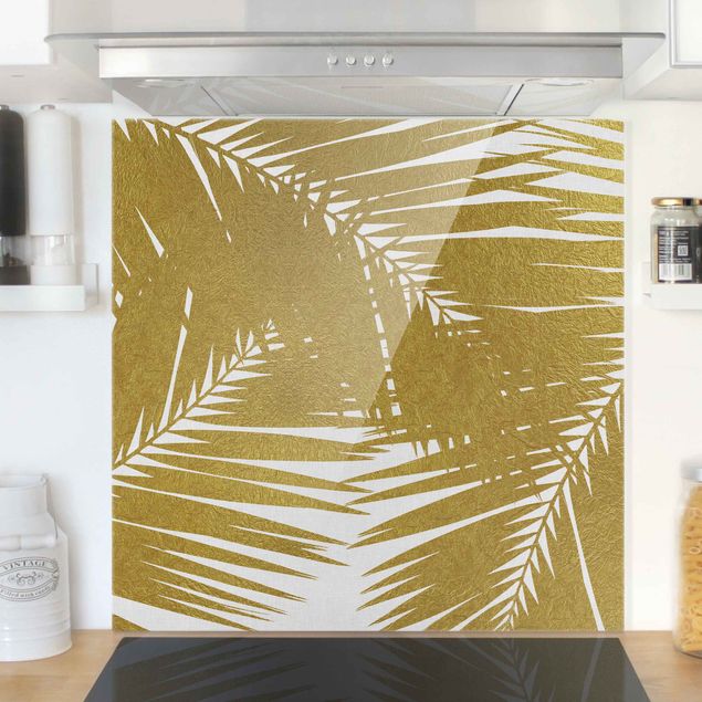 paraschizzi cucina vetro magnetico Vista attraverso le foglie di palma dorate