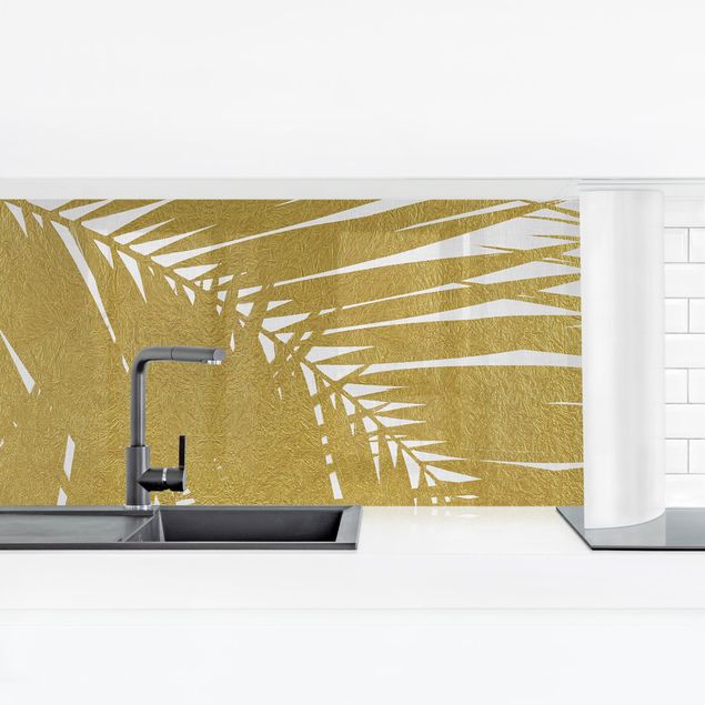 Rivestimenti cucina adesivi Vista attraverso le foglie di palma dorate