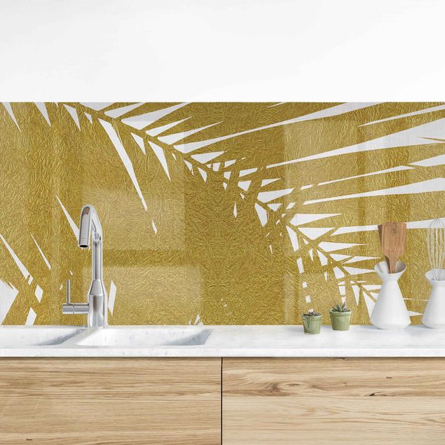 Rivestimenti cucina pannello Vista attraverso le foglie di palma dorate