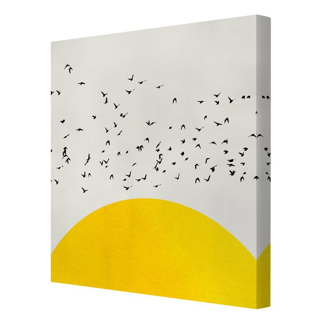 Quadro su tela animali Stormo di uccelli di fronte al sole giallo