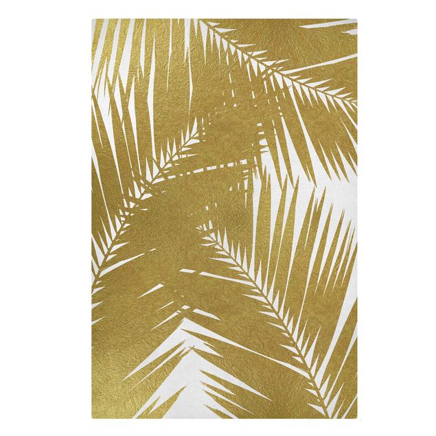 Quadri su tela Vista attraverso le foglie di palma dorate