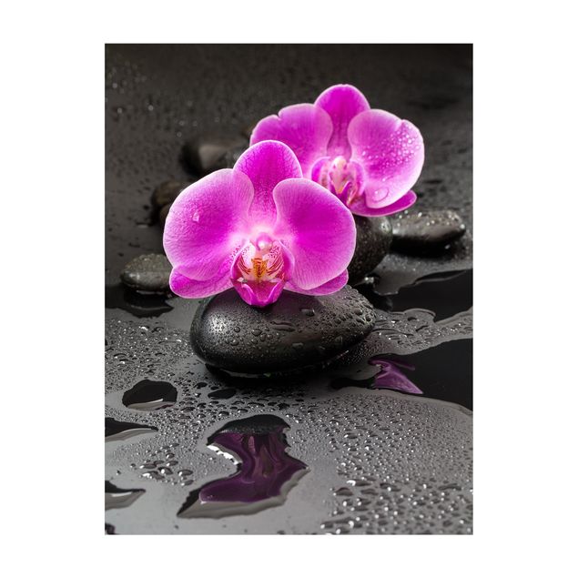 Tappeti effetto pietra Fiore di orchidea rosa su pietra con gocce