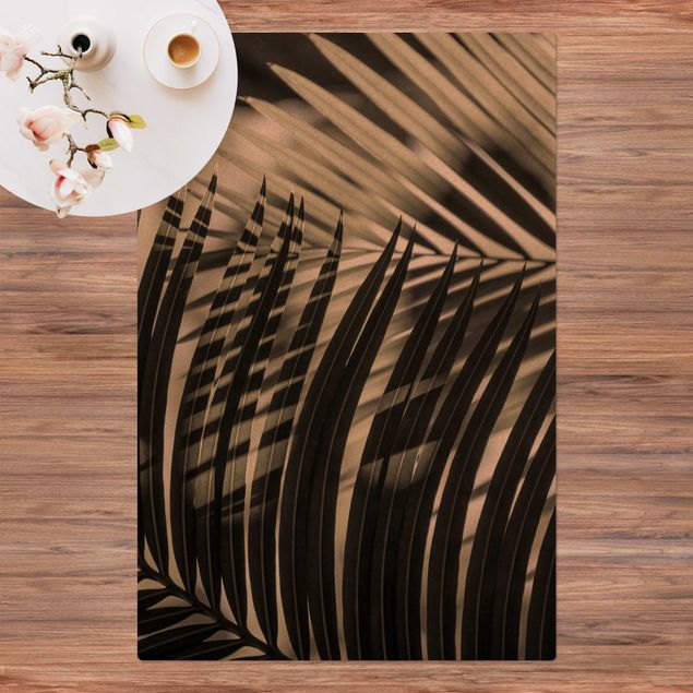 Tappeti moderni Giochi di ombre su ramo di palma