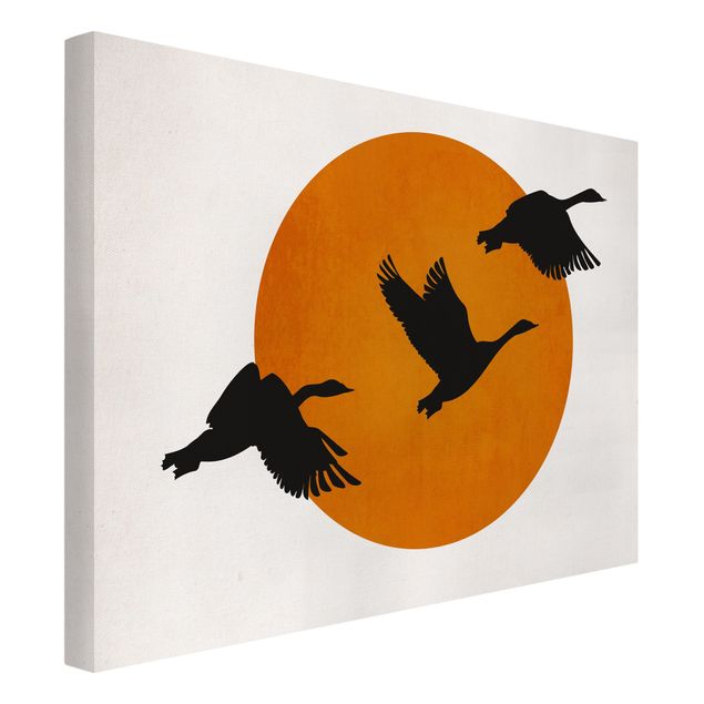 Stampe su tela paesaggio Uccelli di fronte al sole rosso